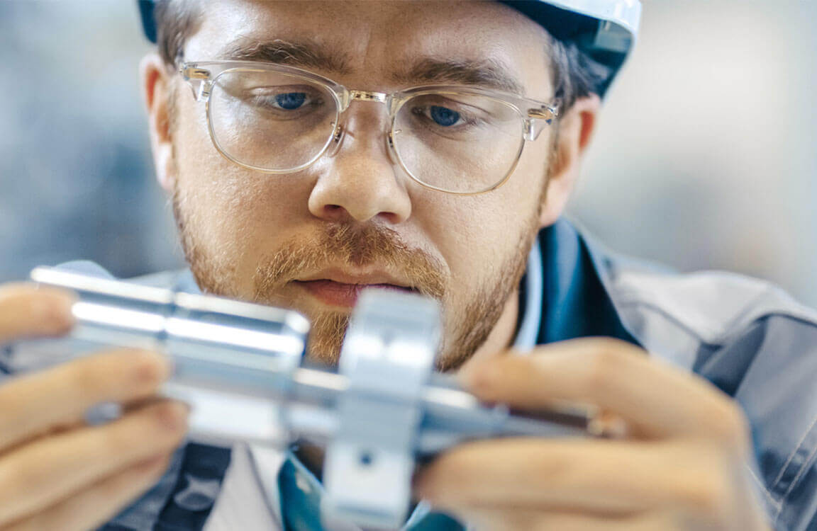 An engineer holding a piece of equipment