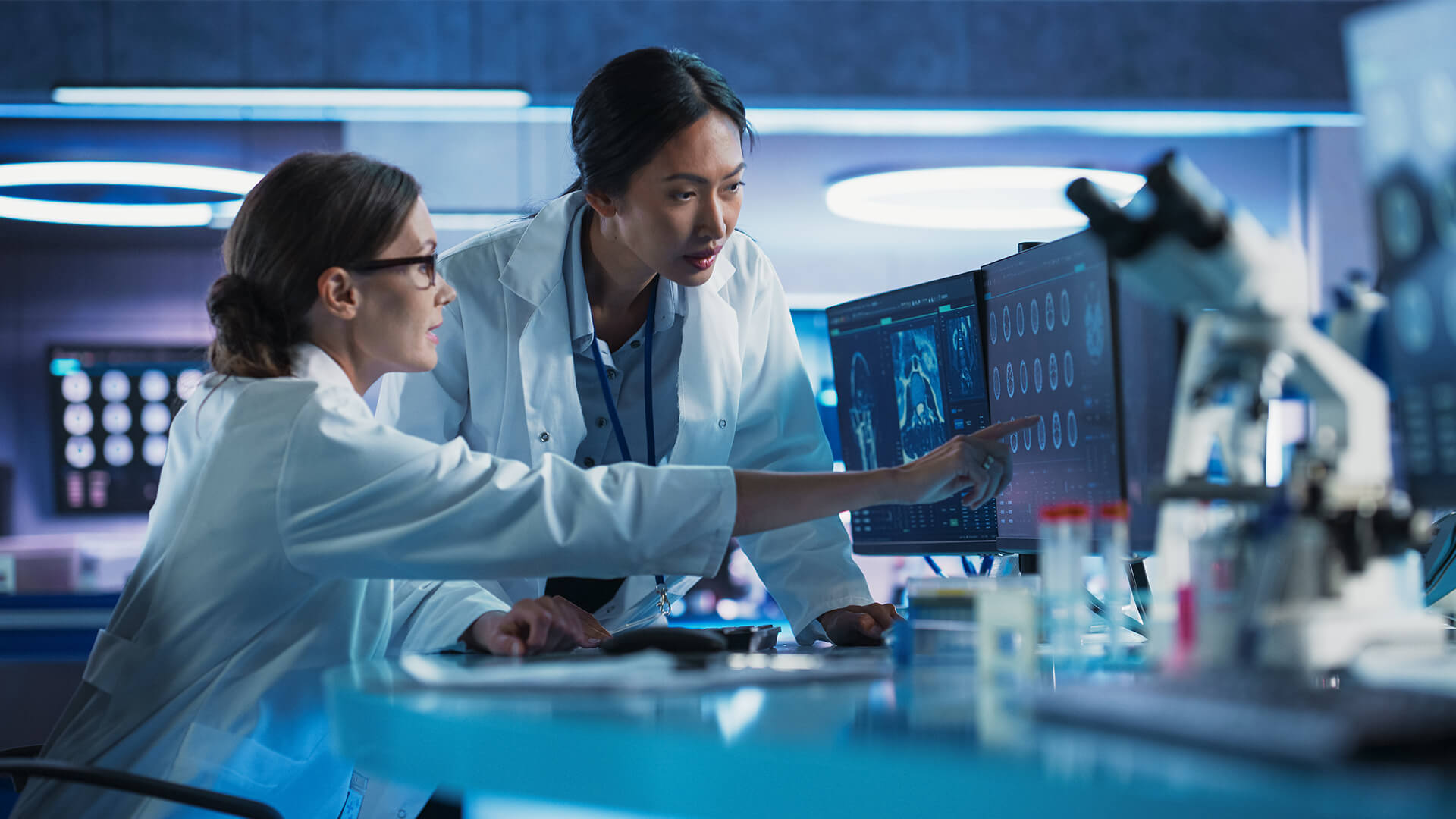 Consultants with sciences expertise product testing pharmaceutical therapies in a lab.