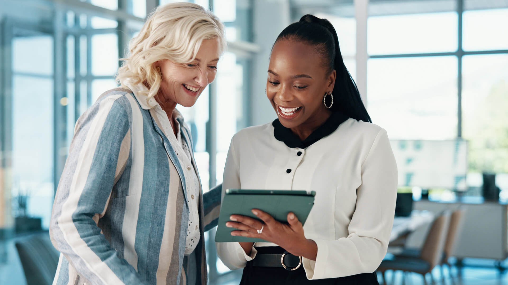 Female professionals reviewing the February 2026  jobs report on an iPad looking at January  2026 labor market and economy trends.
