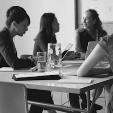 Women working together in a conference space