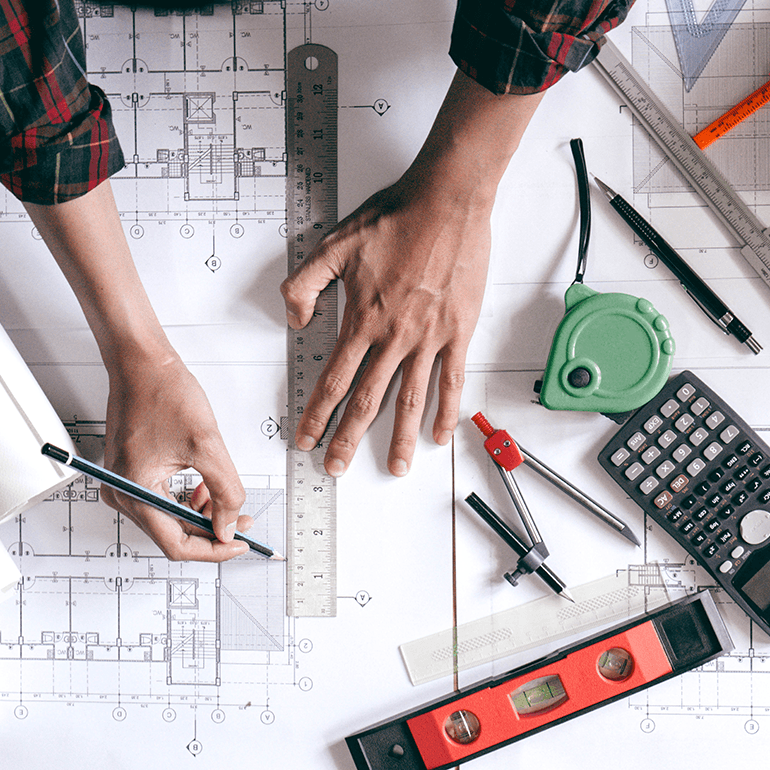 hands working on blueprint